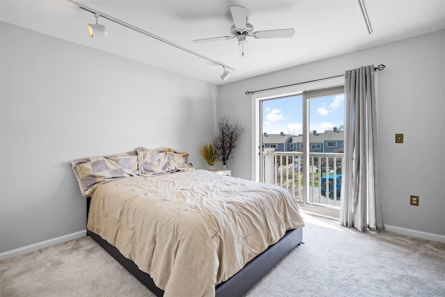 carpeted bedroom featuring track lighting, a ceiling fan, access to outside, and baseboards
