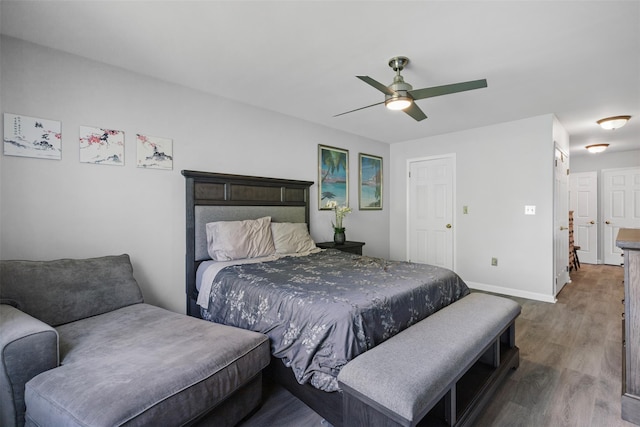 bedroom featuring a ceiling fan, wood finished floors, and baseboards