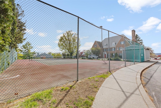 view of sport court with fence
