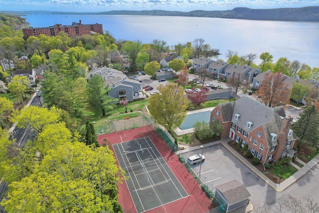 drone / aerial view featuring a residential view and a water view