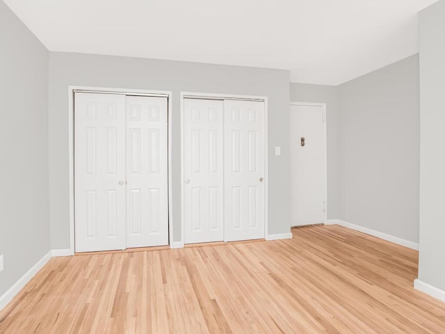 6535 Broadway Unit 5C, Bronx, NY 10471 - unfurnished bedroom with two closets, light wood-style floors, and baseboards