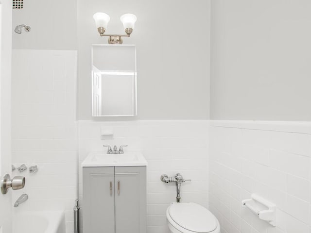 6535 Broadway Unit 5C, Bronx, NY 10471 - full bathroom with toilet, vanity, tile walls, a wainscoted wall, and bathtub / shower combination