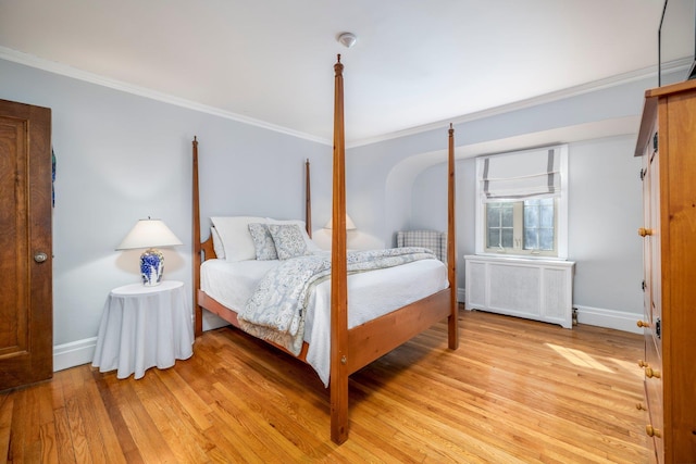 bedroom with baseboards, ornamental molding, and radiator