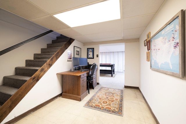 office area with baseboards and a paneled ceiling