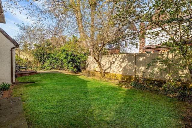 view of yard with fence and a wooden deck
