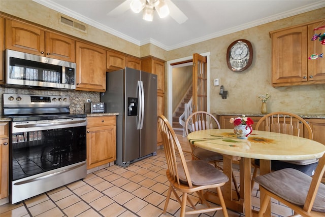 kitchen with decorative backsplash, appliances with stainless steel finishes, brown cabinets, visible vents, and a ceiling fan