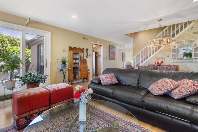 living area featuring visible vents, stairway, a notable chandelier, and recessed lighting