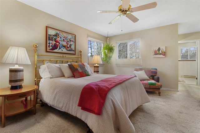 bedroom with ceiling fan, baseboards, a baseboard heating unit, and carpet floors