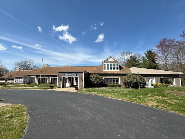 view of front facade with french doors and a front lawn