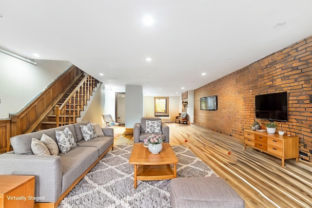 201 Madison St, Brooklyn, NY 11216 - living room featuring recessed lighting, light wood-style flooring, stairs, and brick wall