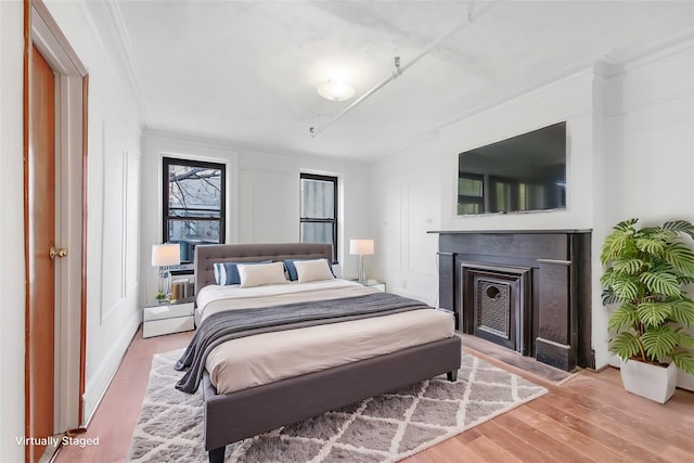 201 Madison St, Brooklyn, NY 11216 - bedroom featuring crown molding, a fireplace, and wood finished floors