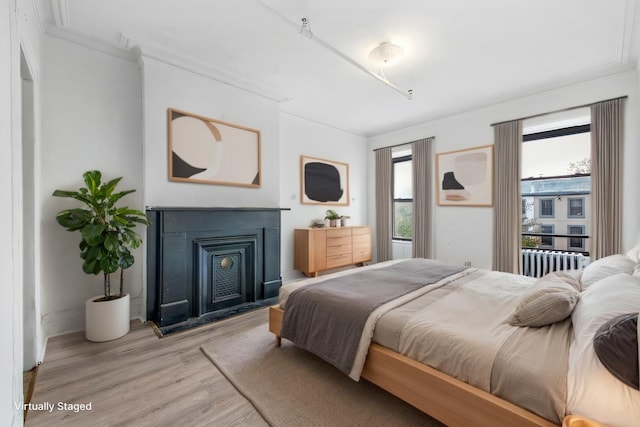 201 Madison St, Brooklyn, NY 11216 - bedroom featuring crown molding, radiator, and light wood-style floors
