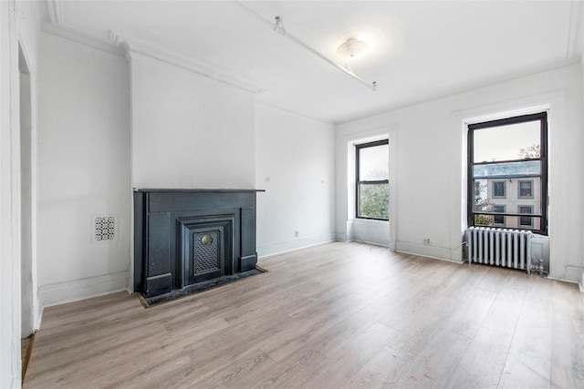201 Madison St, Brooklyn, NY 11216 - unfurnished living room featuring crown molding, light wood-style flooring, radiator, baseboards, and visible vents