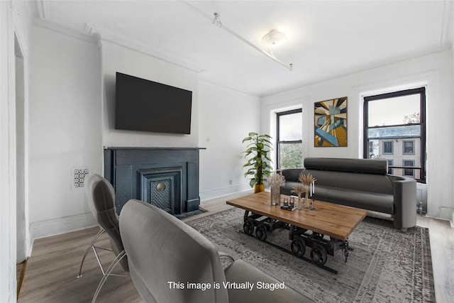 201 Madison St, Brooklyn, NY 11216 - living area with visible vents, ornamental molding, wood finished floors, baseboards, and a fireplace with flush hearth