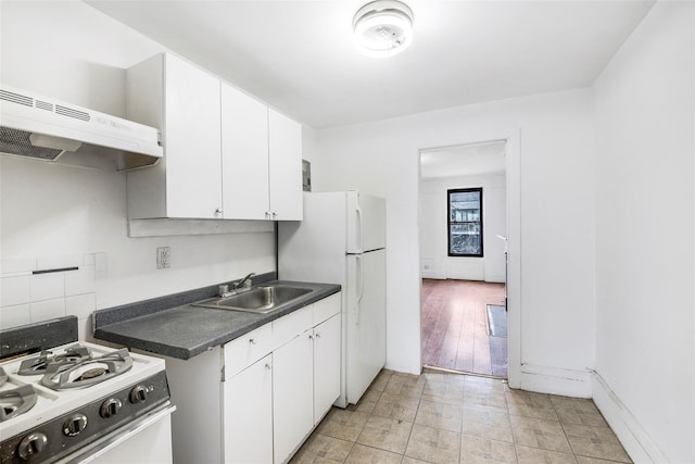 201 Madison St, Brooklyn, NY 11216 - kitchen with white cabinets, dark countertops, a sink, white appliances, and under cabinet range hood