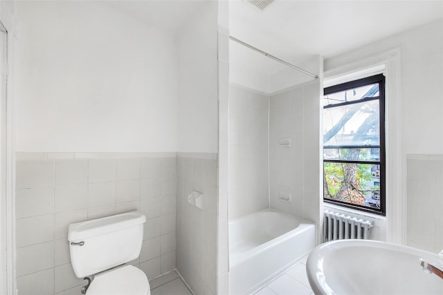 201 Madison St, Brooklyn, NY 11216 - bathroom featuring radiator, a bath, toilet, and tile walls