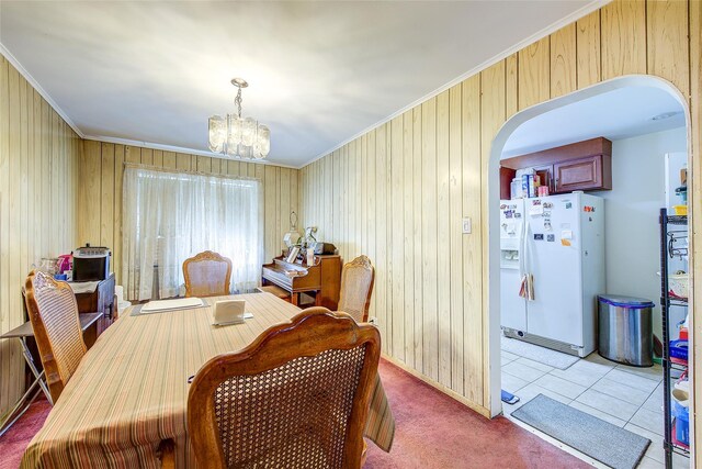 225-54 Murdock Ave, Queens Village, NY 11429 - dining area featuring crown molding, arched walkways, an inviting chandelier, and wood walls