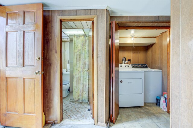 225-54 Murdock Ave, Queens Village, NY 11429 - clothes washing area with wood walls, washer and clothes dryer, and laundry area
