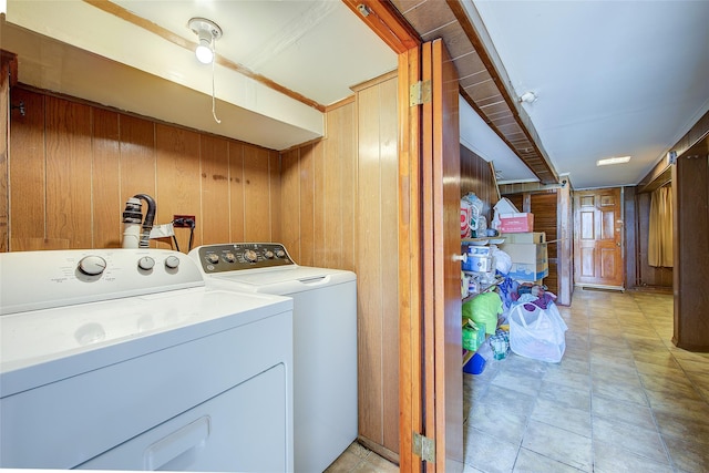 225-54 Murdock Ave, Queens Village, NY 11429 - laundry area with wood walls, washer and clothes dryer, and laundry area