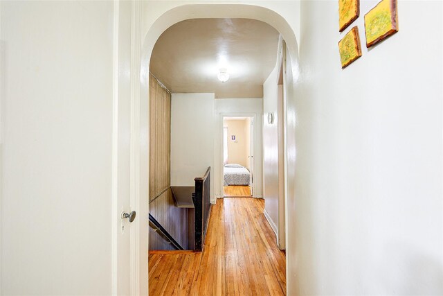 225-54 Murdock Ave, Queens Village, NY 11429 - hallway featuring an upstairs landing, arched walkways, and light wood-style floors