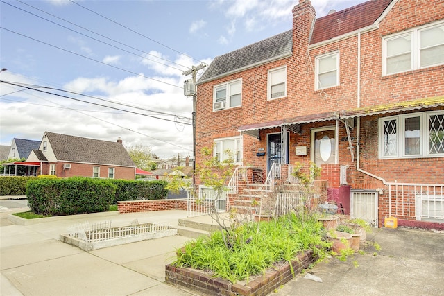225-54 Murdock Ave, Queens Village, NY 11429 - view of property featuring a chimney and brick siding