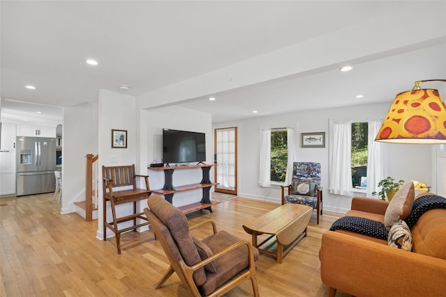 living room featuring baseboards, recessed lighting, and light wood-style flooring