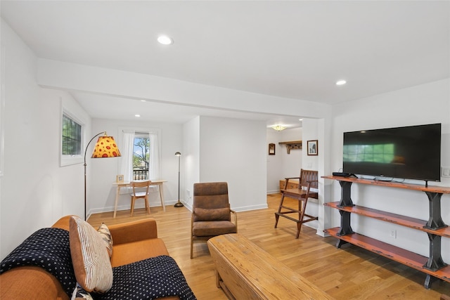 living room with recessed lighting, baseboards, and light wood finished floors