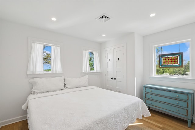 bedroom featuring visible vents, recessed lighting, and light wood-style floors