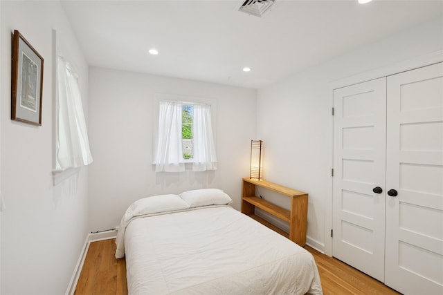 bedroom featuring recessed lighting, baseboards, light wood finished floors, and visible vents