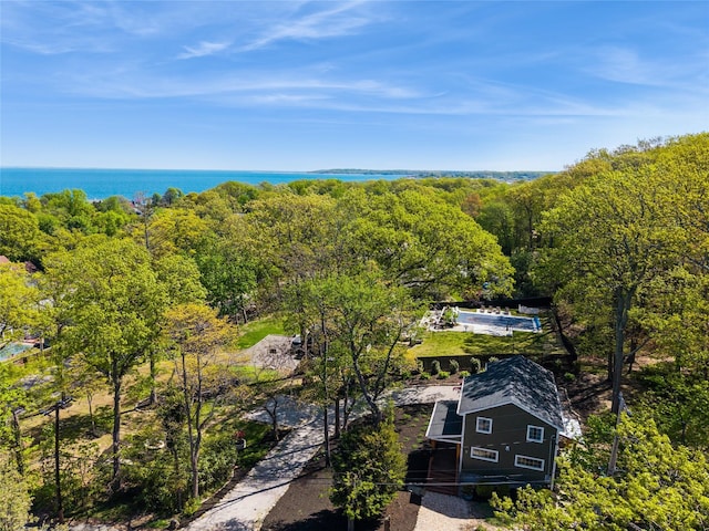 drone / aerial view with a water view and a forest view
