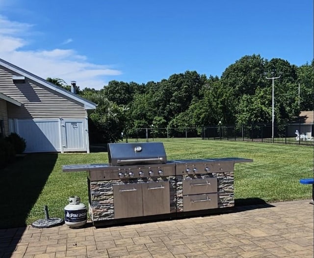 view of patio / terrace featuring area for grilling, a grill, and fence