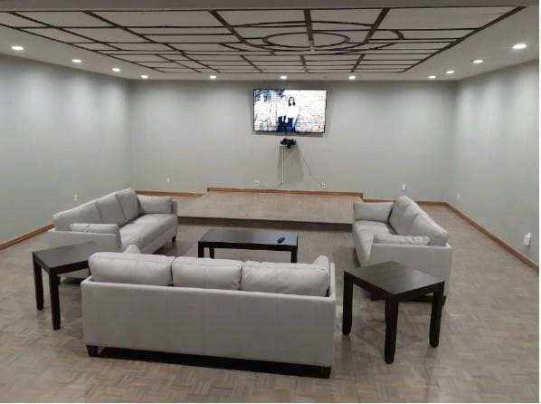 living area featuring baseboards and recessed lighting