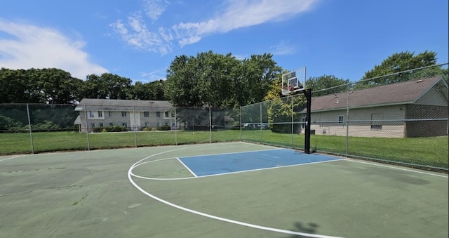 view of sport court featuring community basketball court, fence, and a lawn