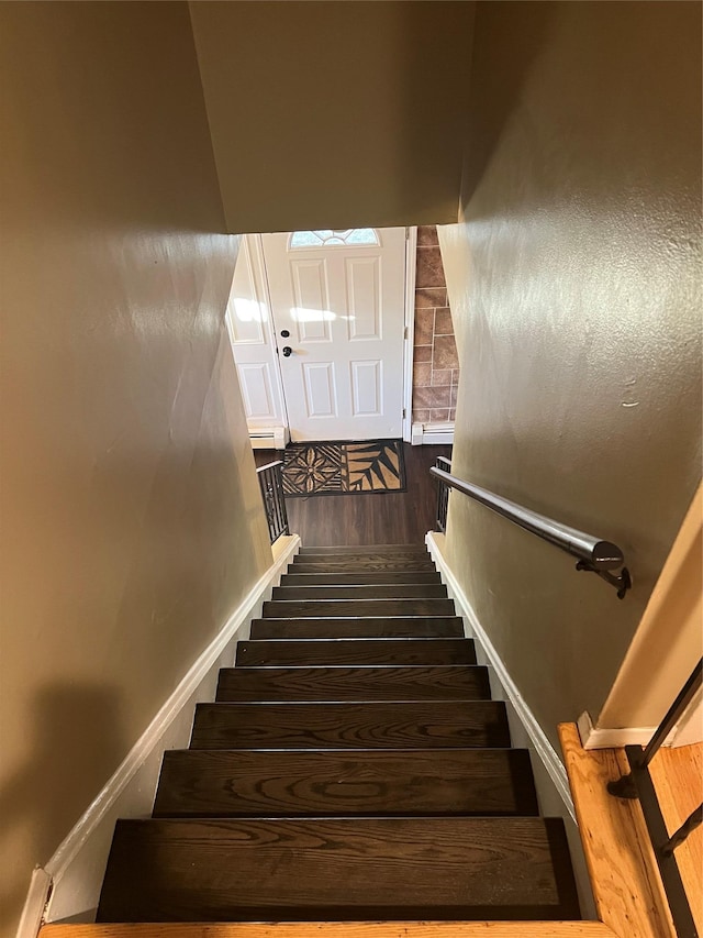 staircase featuring wood finished floors