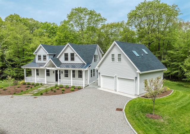 16 Anderson Rd, Pawling, NY 12564 - view of front of house featuring a standing seam roof, driveway, covered porch, metal roof, and a garage