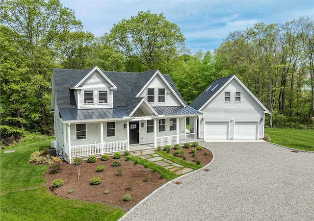 16 Anderson Rd, Pawling, NY 12564 - view of front of house featuring a porch, a standing seam roof, a garage, gravel driveway, and a front lawn
