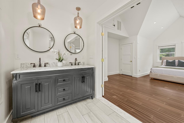 16 Anderson Rd, Pawling, NY 12564 - bathroom with double vanity, wood finished floors, lofted ceiling, and baseboards