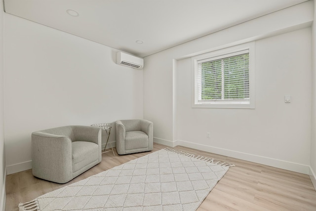 16 Anderson Rd, Pawling, NY 12564 - sitting room featuring an AC wall unit, baseboards, and wood finished floors