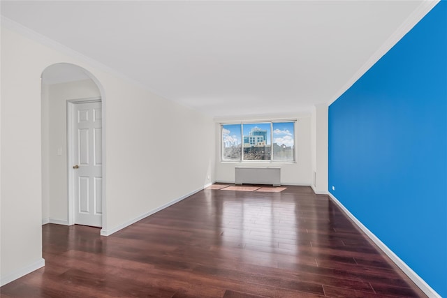 3333 Henry Hudson Pkwy Unit 7C, Bronx, NY 10463 - spare room with wood finished floors, arched walkways, radiator heating unit, baseboards, and crown molding