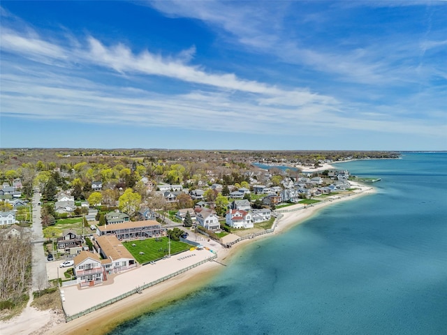 birds eye view of property featuring a beach view, a water view, and a residential view