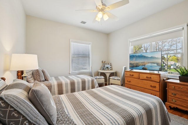 bedroom with ceiling fan and visible vents