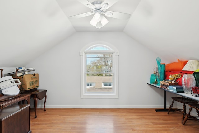 office area with baseboards, ceiling fan, vaulted ceiling, and wood finished floors