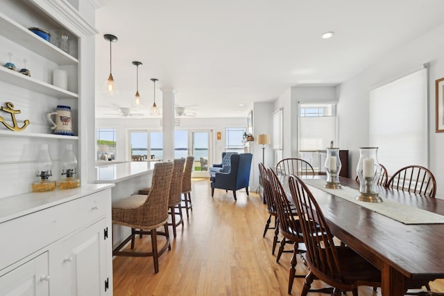 dining area featuring light wood-type flooring and ceiling fan