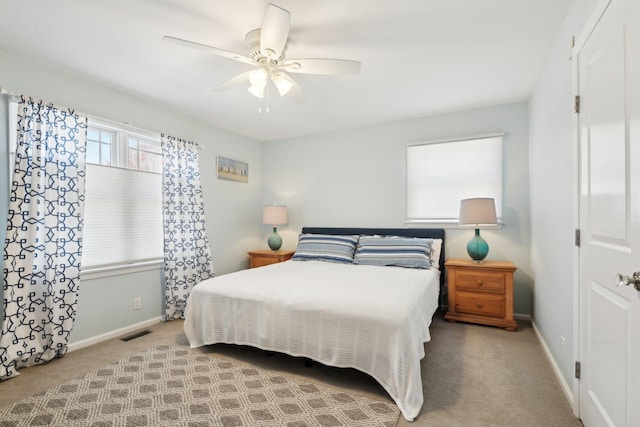 bedroom with carpet floors, baseboards, ceiling fan, and visible vents