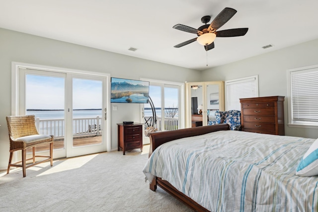 bedroom with visible vents, carpet flooring, and access to exterior