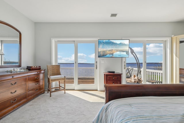 bedroom with visible vents, access to outside, and light colored carpet