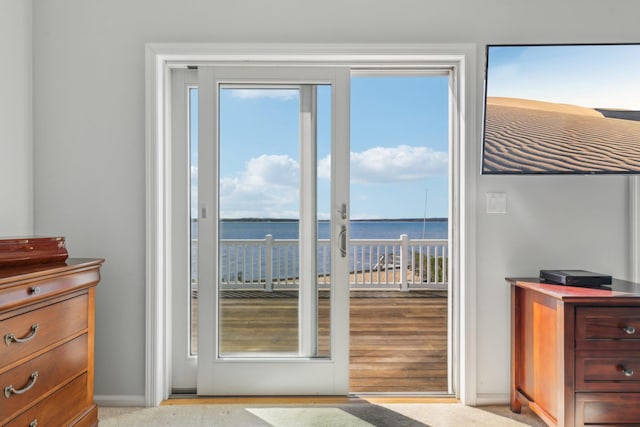 doorway to outside with a water view, baseboards, and a wealth of natural light