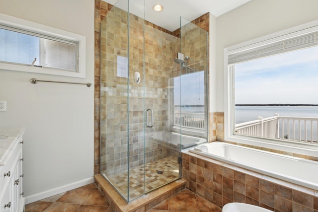full bathroom featuring vanity, tile patterned flooring, a bath, and a shower stall