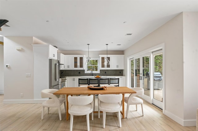 260 Wilmot Rd, Ocean Beach, NY 11770 - dining space with baseboards, visible vents, french doors, and light wood finished floors