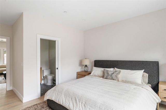 260 Wilmot Rd, Ocean Beach, NY 11770 - bedroom with baseboards, ensuite bathroom, and light wood-style floors
